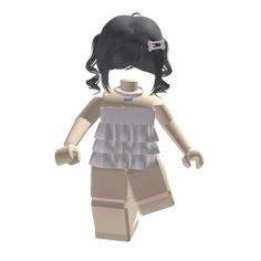 a small doll with black hair and white shirt