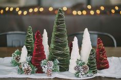 small christmas trees are lined up on a table