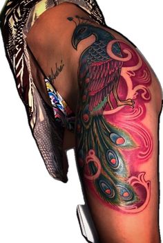 the back of a woman's leg with a tattoo on it and a bird