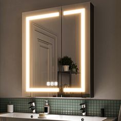 a bathroom with a sink, mirror and lights on the wall above it's counter