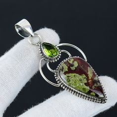 Dragon Blood Jasper, Peridot Gemstone Handmade 925 Sterling Silver Jewelry Pendant Premiun Quality Gemstone Pendant For Women Christmas Gift ❏ Product Information ●  Gemstone Type - Dragon Blood Jasper ●  Secondary Gemstone - Peridot  ●  Main Stone Creation - Natural ●  Pendant Size - 6.5 Cm. ●  Metal Type - 925 Sterling Silver With 925 Stamped ●  United States ( UPS, DHL Express ) ●  Other Countries ( India Post, Dhl ) ●  Free Shipping Worldwide ●  We Will Provide You Tracking number ●  Add Gif Green Natural Gemstones As Gift, Green Gemstones With Accents For Gifts, Green Gemstones With Accents As Gifts, Green Multi-stone Gemstones For Gift, Green Gemstones With Stone Setting For Gifts, Petrified Wood Jewelry, Dragon Blood, Pendant For Women, Peridot Gemstone