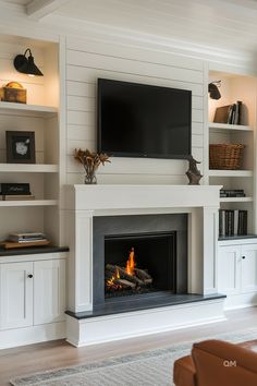 a living room with a fire place and television mounted on the wall above it's fireplace