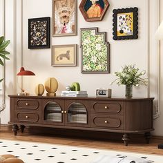 a living room with pictures on the wall and a dog bed in front of it