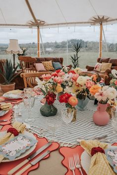 the table is set with flowers and place settings