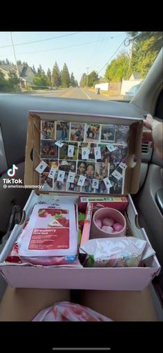 an open suitcase sitting in the back seat of a car filled with pictures and photos