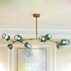 a chandelier hanging from the ceiling in a living room