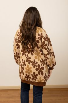 This unlined cardigan features a button-front closure, making it easy to layer over various outfits. The balloon sleeves add a touch of modern elegance, enhancing the overall design with a flattering and dramatic silhouette. The rich brown floral pattern adds a charming detail, making this cardigan a versatile piece for both casual and semi-formal occasions. Ideal for layering in cooler weather, it provides both warmth and a stylish, comfortable fit.Model & Fit Model: Tiffanee (5' 7" and Size 6 Trendy Brown Long Sleeve Sweater, Oversized Balloon Sleeve Sweater For Fall, Oversized Puff Sleeve Sweater For Fall, Brown V-neck Relaxed Fit Cardigan, Brown Relaxed Fit V-neck Cardigan, Brown V-neck Cardigan For Spring, Brown V-neck Cardigan For Fall, Oversized Brown Cardigan For Spring, Retro Brown Sweater For Fall