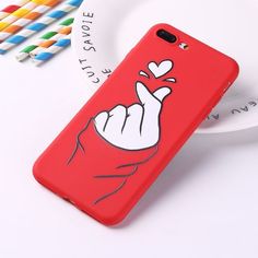 a red phone case with a cartoon hand holding a heart on the front and side