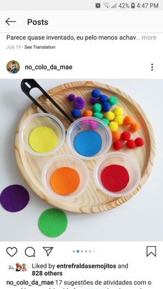 a wooden plate filled with different colored paints