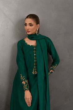 SKU: 1025 Price for Shirt and inner only.Amongst the deepest shade of green this stunning creation is crafted using the finest raw silk adorned with beautiful French knots work further garnished with lovely pearls and sequins. Paired with a same-toned dupatta to complete the look. Elegant Green Sharara With Traditional Drape, Elegant Green Sharara For Diwali, Elegant Green Festive Sharara, Elegant Semi-stitched Green Sharara, Green Dola Silk Salwar Kameez With Long Sleeves, Green Art Silk Salwar Kameez For Party, Elegant Green Dola Silk Traditional Wear, Green Long Sleeve Dola Silk Kurta, Elegant Green Sharara With Dabka