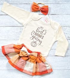 "My First Thanksgiving Outfit, Baby Girl Thanksgiving Dress, Thanksgiving Shirt, Niece Aunt Gift You may choose: ~\"My First Thanksgiving\" bodysuit as shown. Available in short or long sleeve. ~Gorgeous plaid skirt created with very soft flannel fabric. ~Matching fabric bow/headband All items are handmade in our studio with loving care. Christi Creations - creating happy moments one tutu at a time Check out other items in our shop! http://www.christicreations.etsy.com Copyright © 2008 by Christ Thanksgiving Outfit Baby, My First Thanksgiving, Thanksgiving Baby Outfits, Girls Thanksgiving Outfit, Fabric Matching, Thanksgiving Dress, Girls Thanksgiving