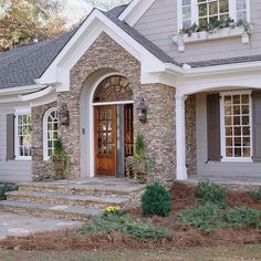 a house with stone and wood trim on the front door