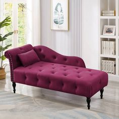 a fuchsia colored chaise lounge couch in a living room