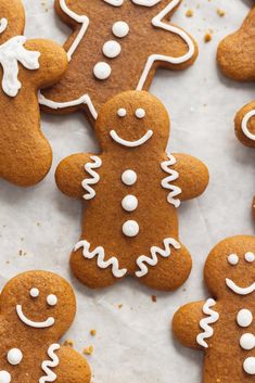 several ginger cookies with white frosting on top