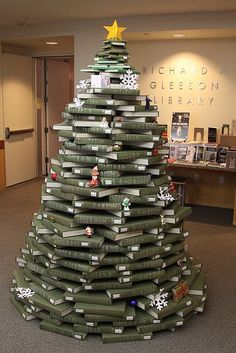 a christmas tree made out of books in an office