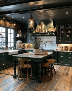 a large kitchen with green cabinets and wooden flooring on the walls is lit by pendant lights that hang from the ceiling