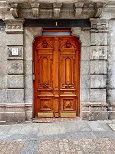 an old wooden door on the side of a building