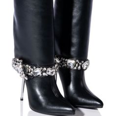 The Azalea Wang" Dripping Fold Over Rhinestone" Gem Stiletto Bootie In Black Is Made From A Chic Vegan Leather Upper And Features A Mid-Calf Height Shaft, A Covered Reflective Stiletto Heel, A Pointed Toe Silhouette, And A Pull-On Fit. Complete With A Clustered Rhinestone Gem-Detailed Band Around The Ankle. - Vegan Leather Upper - Pointed Toe - Stiletto Heel - 13.75” Shaft Height - 4.25” Heel Height Leather Party Boots With Rhinestone Fringe, Party Leather Boots With Rhinestone Fringe, Elegant High Heel Boots With Rhinestone Rivets, Elegant High Heel Boots With Rhinestone Fringe, Elegant Leather Boots With Rhinestones, Elegant Leather Boots With Bling, Elegant Heels With Rhinestone Fringe For Formal Occasions, Elegant Heels With Rhinestone Fringe For Formal Events, Elegant Formal Heels With Rhinestone Fringe