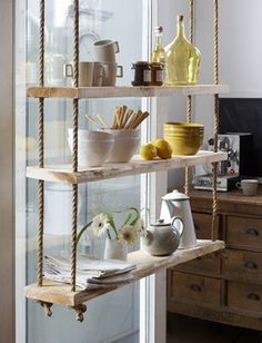 the shelves are filled with dishes and cups