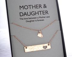 mother and daughter necklaces displayed on display