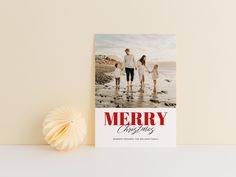 a merry christmas card sitting on top of a table