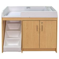 a white sink sitting under a wooden cabinet