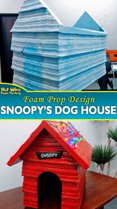 a dog house made out of stacks of paper on top of a table with the words snoopy's dog house