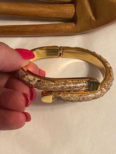 "When I was a working lady and loaded my wrists with bracelets of all kinds, this style of hinged bangle was a favorite style.   This bracelet is for a small wrist and will fit right at the wrist bone.  No name but it is heavily gold plated.  3/8\" wide. The brownish beige taupe color of the bangle is snake skin, roughly textured and very organic.  As I wore this I periodically applies a clear lacquer to keep the scales from drying out and/or peeling away.   So unlike a faux snake skin, this has Hinged Cuff Bracelet For Formal Occasions, Elegant Adjustable Snake Bangle, Party Bracelets With Hinged Detail, Snake Skin Bracelet, Working Lady, Snake Bangle, Chic Shirts, Taupe Color, Hinged Bangle