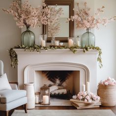 a living room filled with furniture and a fire place covered in pink flowers on top of a mantel