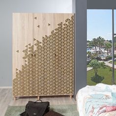 a bedroom with a large wooden cabinet next to a window and a rug on the floor