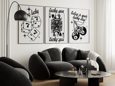 three black and white posters hang on the wall above a couch in a living room