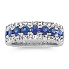 This 14-karat white gold band features traditional blue natural sapphires along the center with sparkling natural diamond borders. It offers a beautiful  bold look  making a gorgeous anniversary gift  wedding band  or daily accessory. Sapphire Ring With Pave Setting And Round Cut, Sapphire Ring With Pave Setting, Classic Sapphire Rings With Pave Setting, Round Sapphire Ring With Pave Setting, Classic Sapphire Ring With Pave Setting, Sapphire Ring With Diamond Accents Round Cut, Sapphire Rings With Pave Setting, Round Cut, Formal Blue Sapphire Eternity Band, Fine Jewelry Sapphire Eternity Band With Round Cut