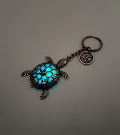 a keychain with a glowing turtle on it