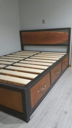 a bed with two drawers on top of it