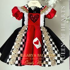 a dress made to look like a child's costume with hearts on the chest