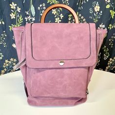 Nwt Violet Ray Kendall Backpack In Wine - New With Tags - 12" H X 13" W X 5" D - Faux Leather - Adjustable Straps - Wooden D-Ring Handle That Can Fold Up/Down - Fold Over Flap With Snap Closure - Snap Closure Is Half Faux Marble, Half Gold Veneer - Sides Can Unzip And Be Let Out For Additional Expansion, Or Zipped Up For A More Uniform Look Pockets - 1 External Zip Pocket On Front - 1 Internal Zip Pocket - 2 Internal Slip Pockets This Backpack Has Never Been Used. There Is A Little Bit Of Yellow Violet Ray Handbags, Ring Handle, Faux Marble, Wine Colored, Folded Up, D Ring, Fold Over, Snap Closure, Zip Pockets