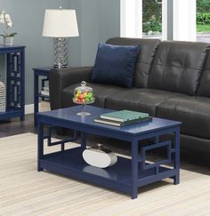 a living room scene with focus on the coffee table and leather sofa in the background