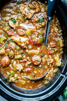 a crock pot filled with shrimp and vegetable stew