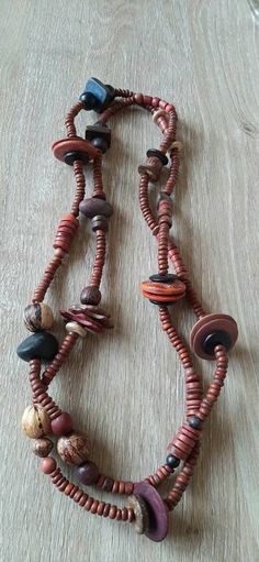 Stunning boho style, chunky beaded necklace with wooden lightweight beads in several sizes and shapes,long enough to double twist it around the neck. Warm red and earthy colour tones,make this necklace a unique but easy to wear colourful  accessory. Cheap Necklaces With Round Wooden Beads, Cheap Vintage Beaded Necklaces With Large Beads, Vintage Wooden Beads Necklaces, Bohemian Brown Long Necklace With Round Beads, Bohemian Long Necklace With Wooden Beads, Wooden Bead Jewelry, Wood Beads Jewelry, Pony Bead Projects, Double Twist