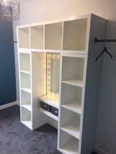 a white bookcase with lights on it in a room