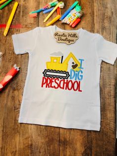 Welcome to our Etsy shop!  This shirt is perfect for the little guy in your life starting school. The embroidery on it is beautiful! The backing I use on children's apparel is thicker and softer than what I use on adult shirts- to provide extra comfort for the kiddos. You can choose to personalize the shirt with a name, it will be added to the dozer in red thread.  Once we hand your package off to UPS or USPS, we are not responsible for lost nor stolen packages. We will help with what we can, but are not responsible after it's out of our hands.  Shirt is 100% cotton.  Shirt color: white  Shirt size options: 3T & 5T Our socials: RusticHillsBoutique on: Instagram TikTok Facebook page.  Rustic Hills Boutique Insiders for our Facebook group. Cotton T-shirt For End Of School Year Playtime, End Of School Year Playtime Cotton T-shirt, Cotton Tops For Playtime And Back To School, Cotton Tops For School Spirit Playtime, Cotton Shirt For School Events, White Cotton Shirt For School Events, White T-shirt For Daycare, Cotton Shirt For End Of School Year Events, School Spirit Cotton Shirt For School Events