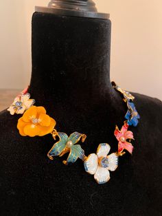 Absolutely stunning showstopper of a necklace from the master costume jeweller, American Kenneth J. Lane. As-new gold plated, enamelled necklace was designed with linked, multi-coloured pansy and lily flowers with faux pearls and crystals. Fabulous gift with box and felted pouch. Slight wear on corners of box; otherwise this beautiful necklace, a true collector's item,i s in as-new condition. Measures 18.9 inches. Marked with Kenneth c Lane Flower sizes range from just over inch to 1.6 inches. Multicolor Costume Jewelry Necklace For Collectors, Vintage Handmade Flower Shaped Necklaces, Vintage Multicolor Flower Jewelry, Luxury Enamel Flower Pendant Necklace, Enamel Flower Charm Necklace, Vintage Flower-shaped Beaded Necklaces, Lucite Jewelry Flower Necklace, Multicolor Flower-shaped Vintage Jewelry, Enamel Necklaces