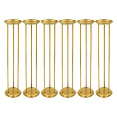 six brass candlesticks in different sizes and shapes, all lined up against a white background