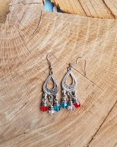 Antiqued Silvertone metal chandelier teardrop earrings in a smaller size. Red, blue and clear faceted glass beads attached. Chandelier base is finished on both sides. All dangling from a silvertone metal French hook earwires that can be changed to a leverback style at your request with no additional cost. Metal Teardrop Beaded Earrings, Silver Teardrop Earrings With Dangling Beads, Metal Teardrop Earrings With Dangling Beads, Silver Beaded Teardrop Earrings, Silver Teardrop Chandelier Earrings With Dangling Beads, Bohemian Dangle Teardrop Earrings With Faceted Beads, Silver Teardrop Crystal Earrings With Dangling Beads, Beaded Metal Teardrop Chandelier Earrings, Silver Teardrop Beaded Earrings With Faceted Beads