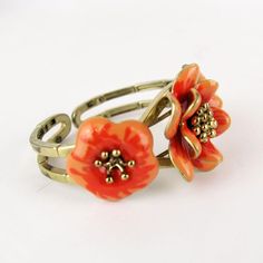 Gorgeous vintage articulated bracelet with enameled flower.       Condition:  Very good preowned condition.  Creator: -  Materials and Techniques:  metal, enamel  Marks:    Date (~):  1960s  Place of Origin:  France  Measurements: Diameter interior 5,5 cm, middle flower 3,5 cm  Weight: circa 70 gr Retro Enamel Bracelet For Gift, Retro Enamel Bracelets For Gift, Retro Enamel Bracelets For Gifts, Retro Handmade Flower Jewelry, Adjustable Metal Flower Ring, Adjustable Flower Shaped Metal Ring, Unique Enamel Flower Jewelry, Adjustable Vintage Flower Shaped Jewelry, Unique Enamel Flower Shaped Jewelry