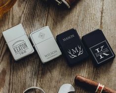 several different types of cigars and lighters on a wooden table next to each other