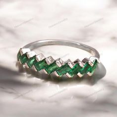 Emerald Wedding Band Unique Baguette Cut Emarald Wedding Ring Women Rose Gold Half Eternity Stacking Gold Ring Anniversary Gift For Her JUST OPENED- Experience beautiful jewelry that complements your everyday style, and completes your look. Our jewelry is so stunning, and so you are. Ring description:- Main Stone: Emerald ( Lab Created ) Main Stone Size: 4x2 MM Main Stone Color: Green Main Stone Shape: Baguette Birthstone Month: May Jewelry Type: Wedding Ring Method: Cast Personalization: Possible Occasion: Engagement Ring Size: We make rings from US 4 to US 10. (If you need smaller or bigger ring size, please ask me to resize) Country of Manufacture: India All our work is custom made by hand with Love and Care in our workshop ♥ CUSTOM ORDERS Please let us know if you want any customizatio Silver Emerald Ring For Wedding, Baguette Cut, Silver Baguette-cut Emerald Ring For Wedding, Silver Emerald Baguette Cut Ring For Wedding, Silver Baguette Cut Emerald Ring For Wedding, Green Emerald Wedding Ring With Baguette Cut, Green Emerald Wedding Ring Baguette Cut, Silver Emerald Half Eternity Ring For Wedding, Wedding Ring Women, Emerald Wedding Band