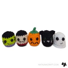 small crocheted pumpkins with faces are lined up in a row on a white background