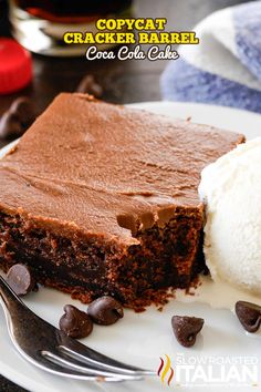 a piece of chocolate cake on a plate with ice cream and chocolate chips next to it