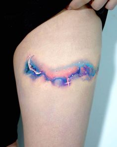 a woman's thigh with the word love written in space painted on her side